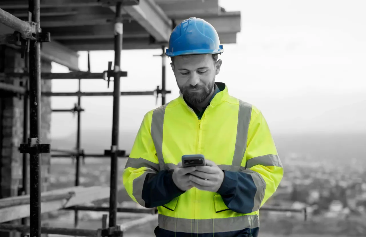 A site operative using his firm's app on a construction site