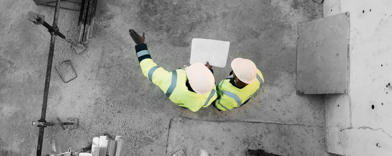 People and architect reviewing construction documents