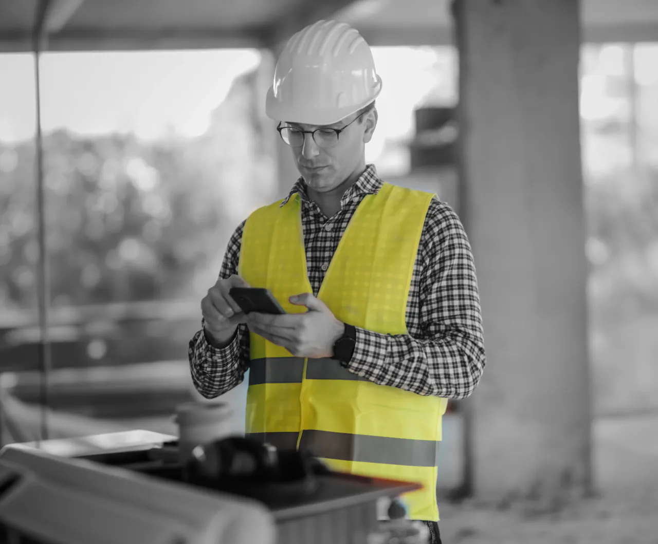 A site manager using a phone on a construction site