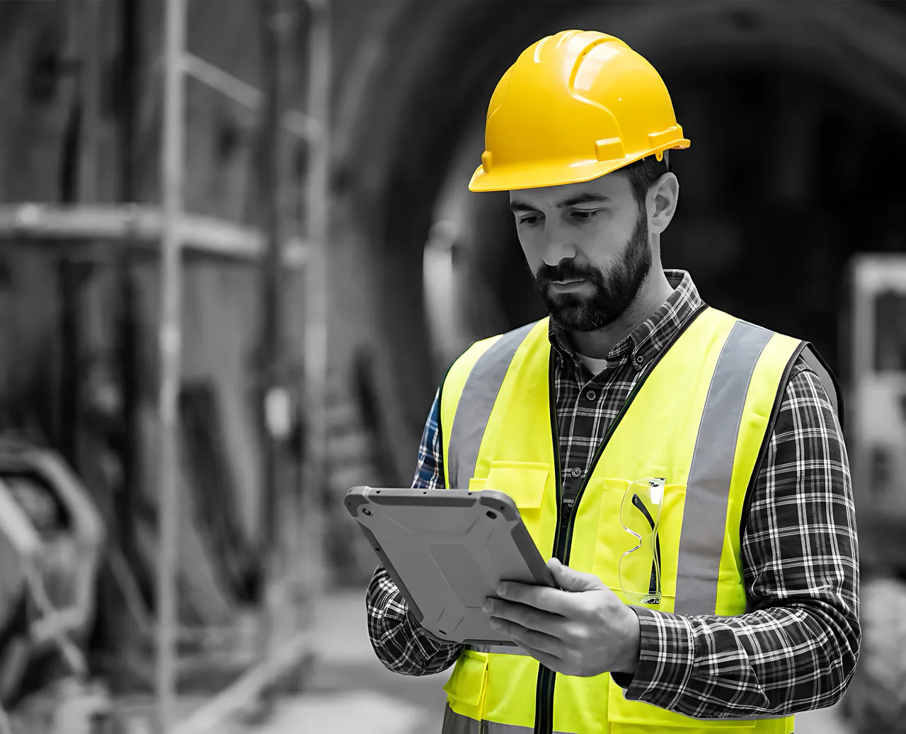 Construction worker reviewing holiday planning information on a tablet