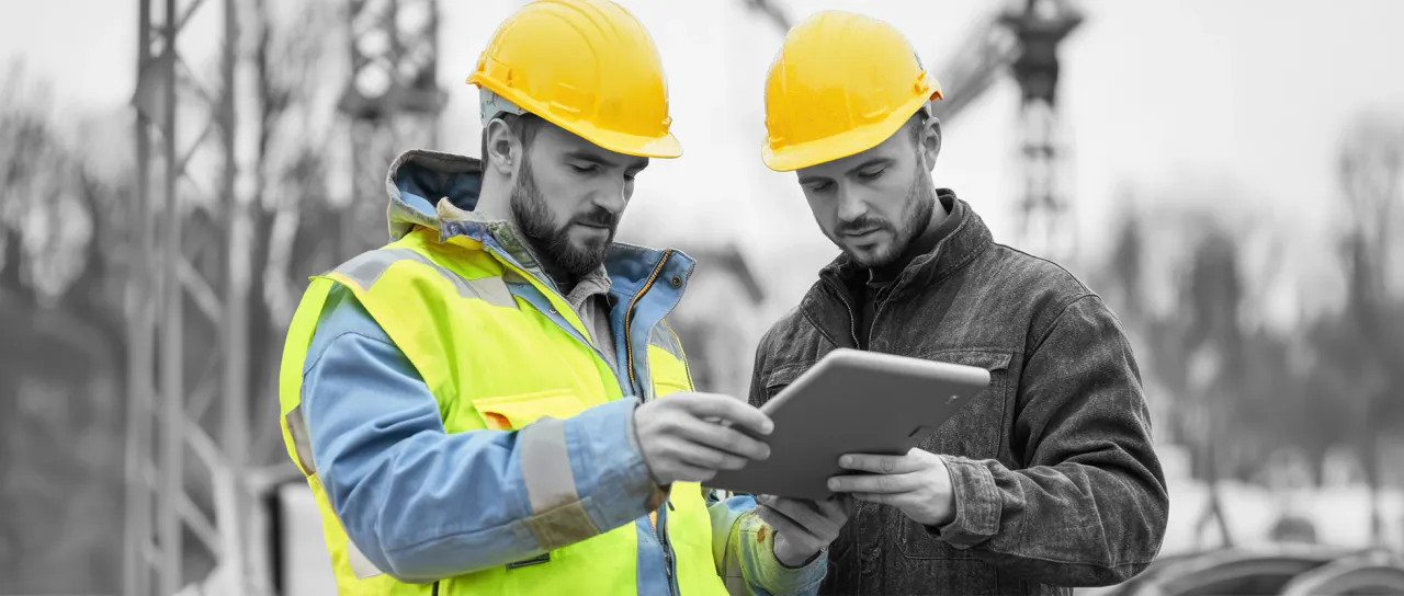 Construction manager reviewing the next week on a tablet