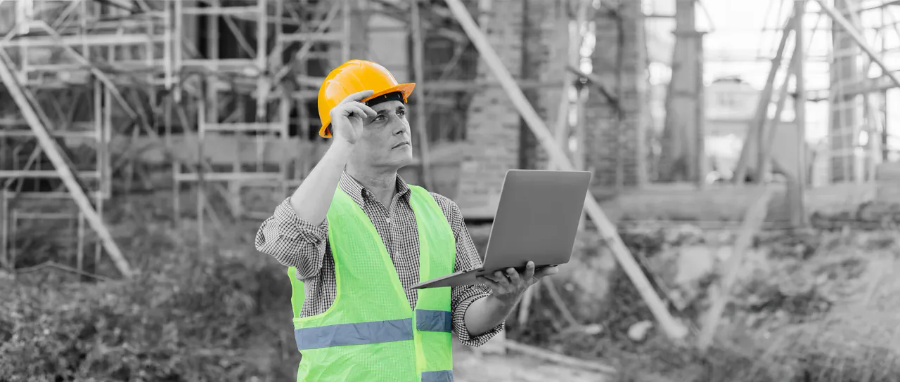 Construction worker reviewing a personnel record on a tablet