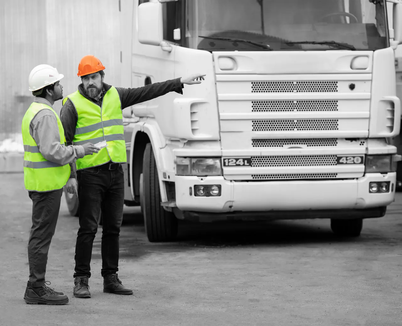 Construction worker reviewing a vehicle and fleet record on a tablet