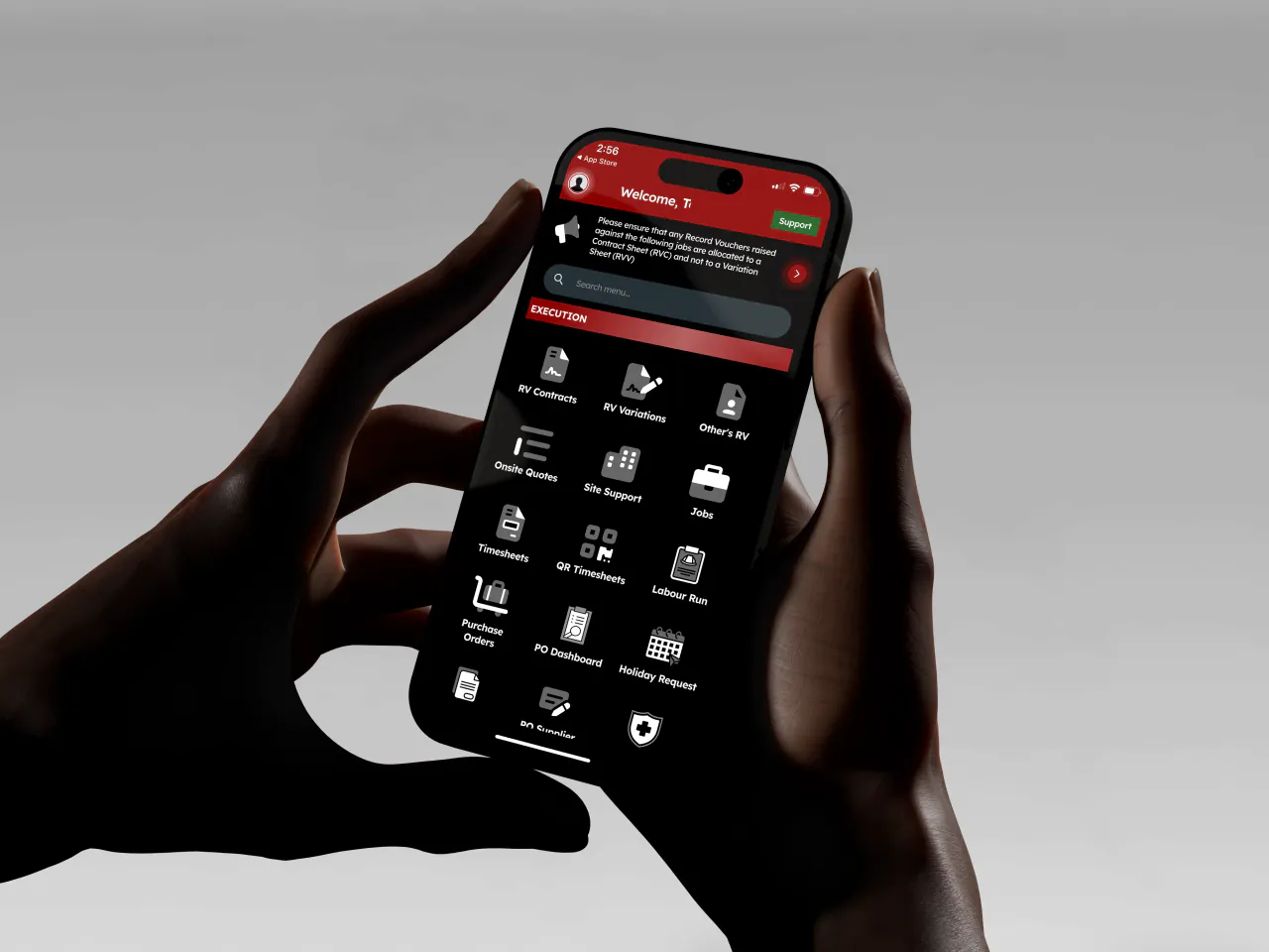 A pair of hands holding a phone open on the Unibuild app, showing the execution menu