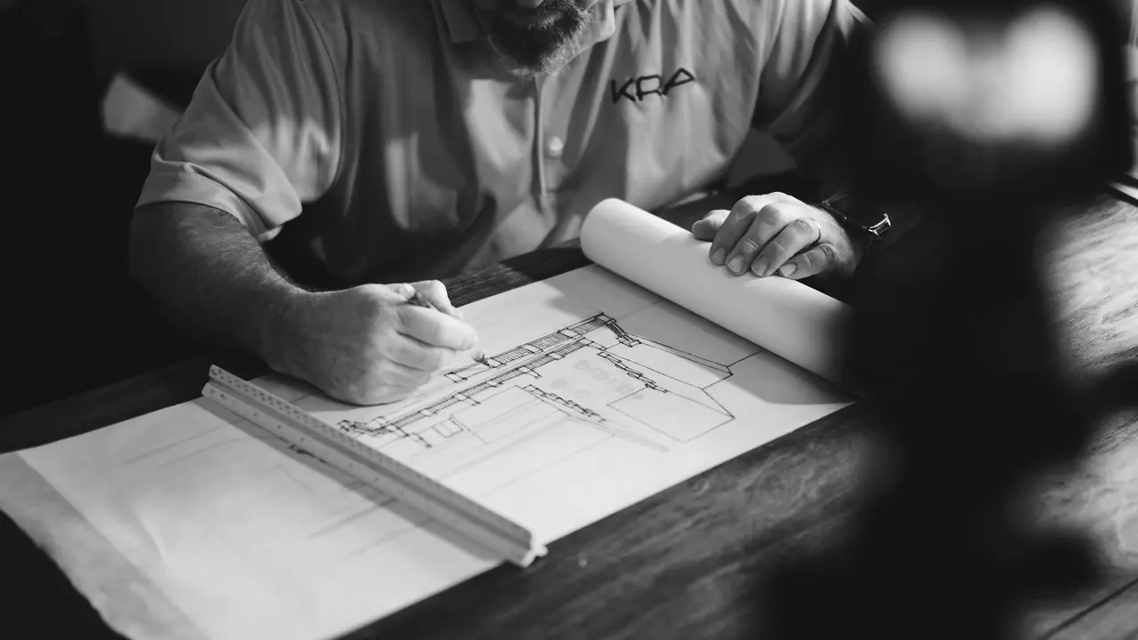 A technical drawing being marked up at a desk