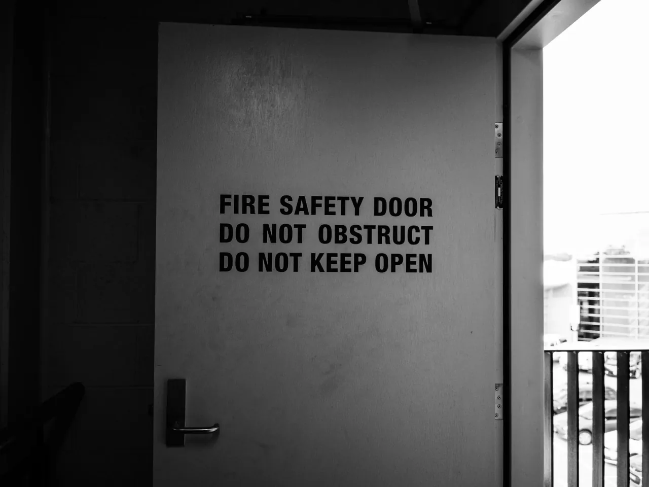 A fire safety door in a stairwell, marked do not obstruct and do not keep open