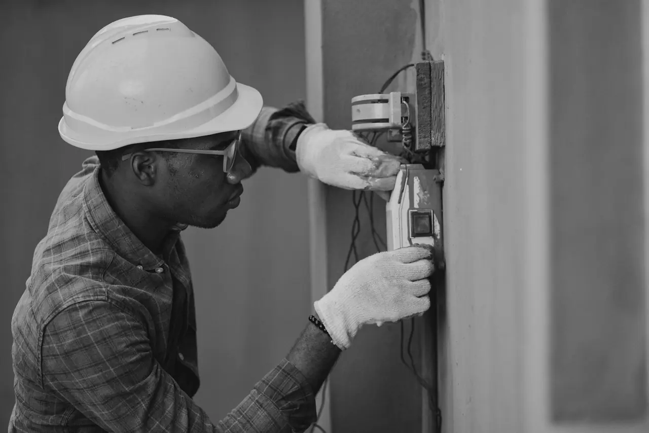 An electrician testing at a distribution board