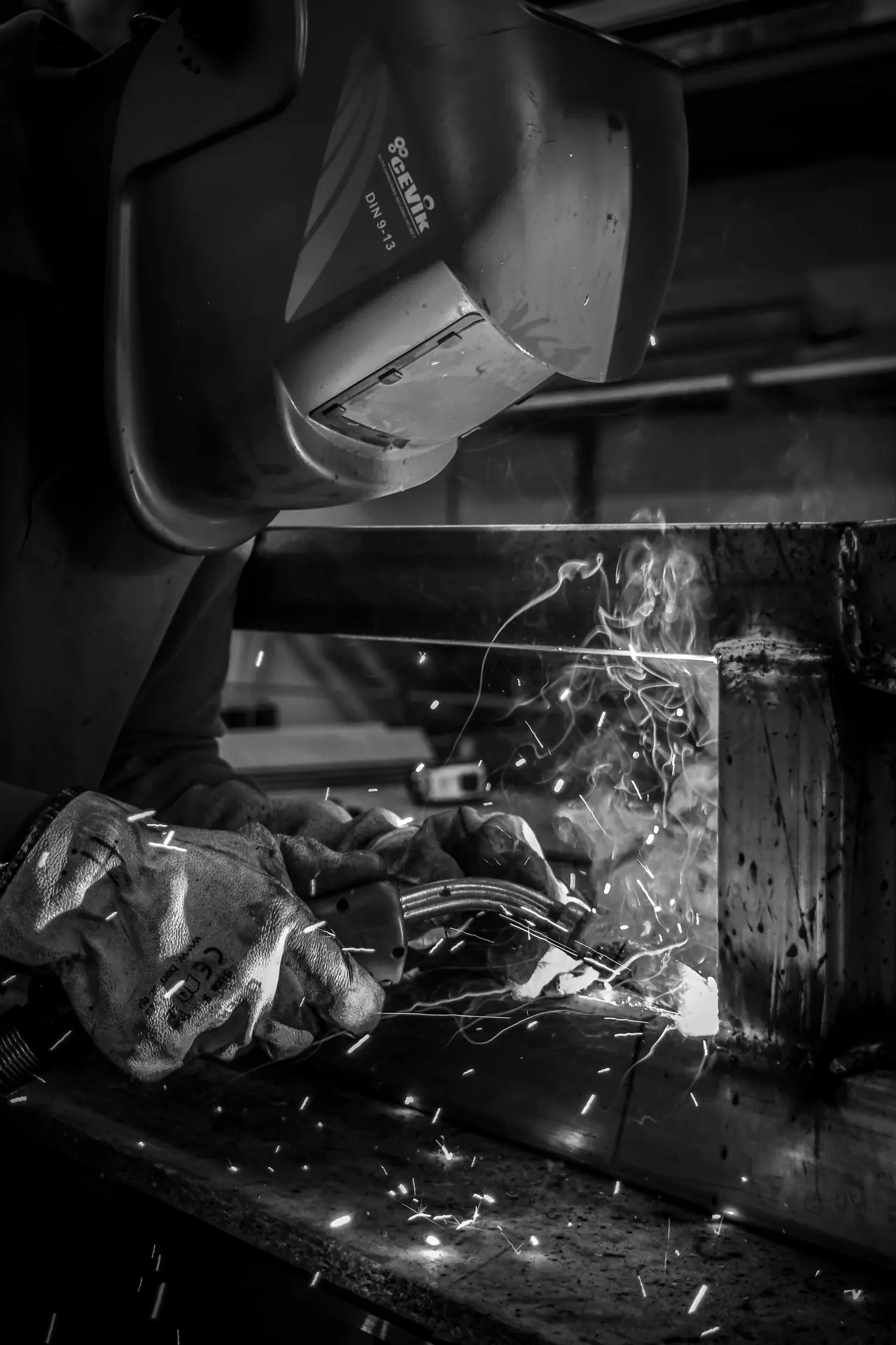 Welder striking an arc, the work a hot work permit covers