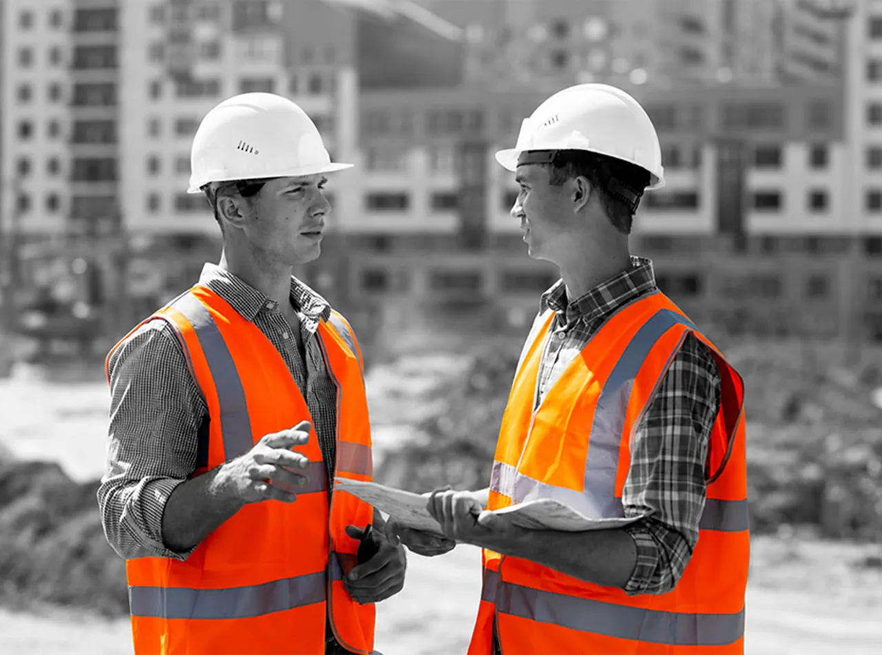 Construction professionals reviewing plans on a UK site